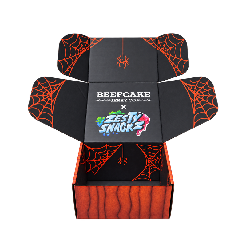 The open BeefCake × Zesty Snackz Halloween collab box with spiderweb artwork inside