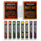 BeeCake Jerky Co. beef jerky product lineup on a white background, featuring two large pouches (Original and Honey BBQ) and eight single-serve sticks in assorted flavor colors.