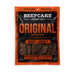 A package of Beefcake Jerky Co. Original Beef Jerky, featuring a black and orange pouch with a clear window showing the dark brown jerky strips inside.