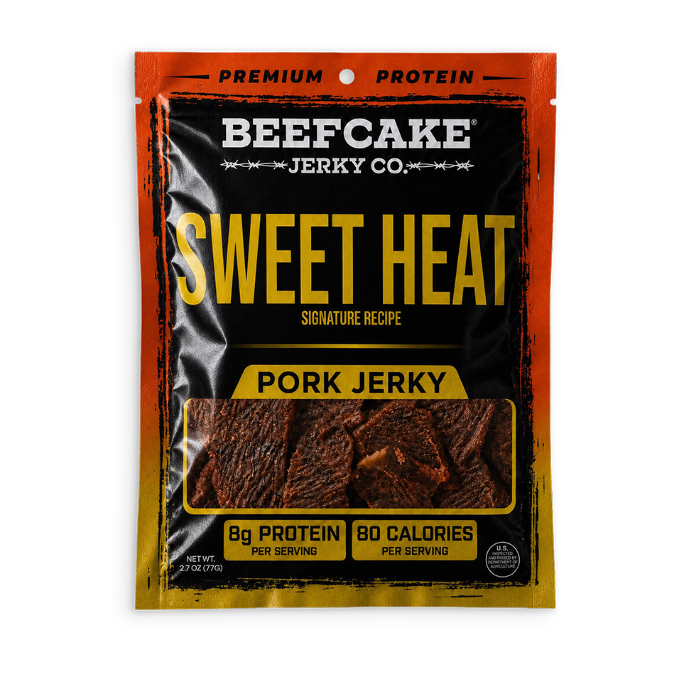 A package of Beefcake Jerky Co. Sweet Heat Pork Jerky, featuring a black and orange bag with yellow text and a clear window showing the jerky slices inside.