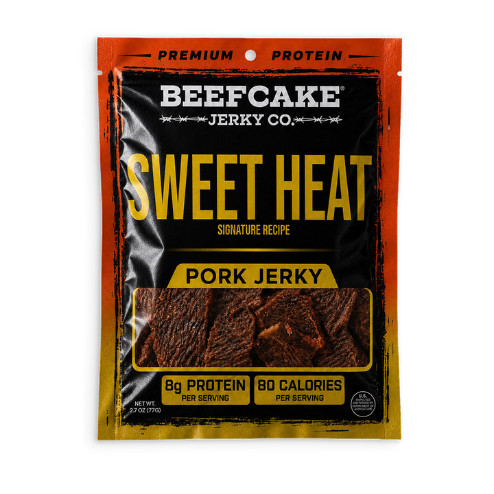 A package of Beefcake Jerky Co. Sweet Heat Pork Jerky, featuring a black and orange bag with yellow text and a clear window showing the jerky slices inside.
