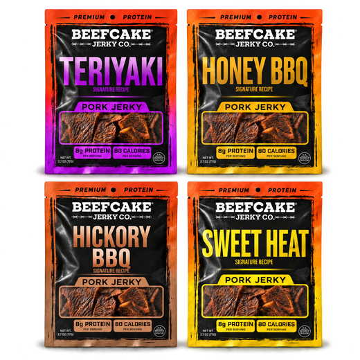 Four BeefCake pork jerky bags laid flat: Teriyaki, Honey BBQ, Hickory BBQ, and Sweet Heat, with soft shadows on a transparent background.