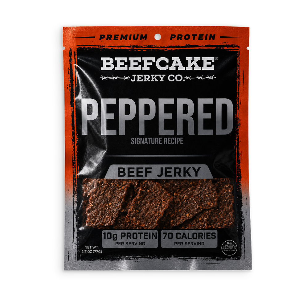 A package of Beefcake Jerky Co. Peppered Beef Jerky, featuring a black and orange resealable pouch with a clear window showing the textured, reddish-brown jerky pieces inside.