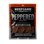 A package of Beefcake Jerky Co. Peppered Beef Jerky, featuring a black and orange resealable pouch with a clear window showing the textured, reddish-brown jerky pieces inside.
